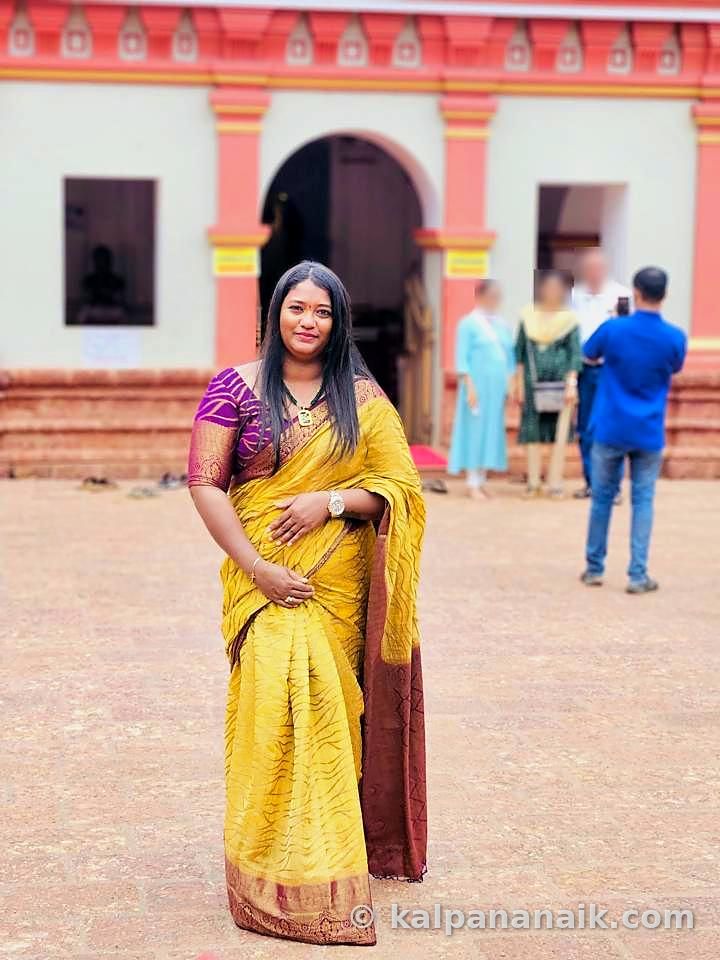 Kalpana in a yellow saree at a heritage church