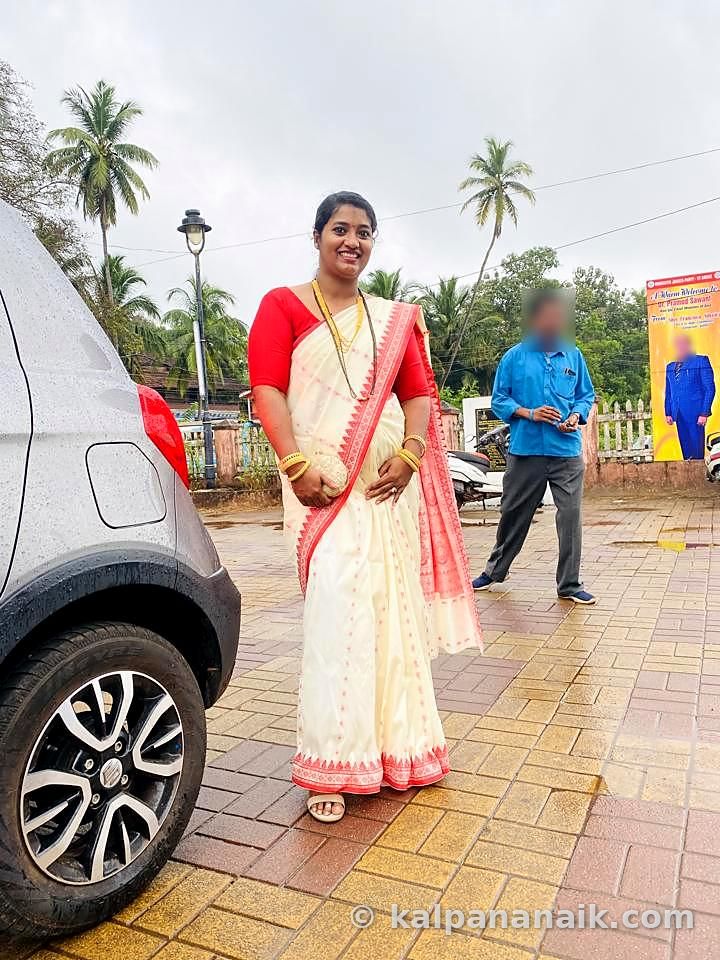 Kalpana in a white and red saree