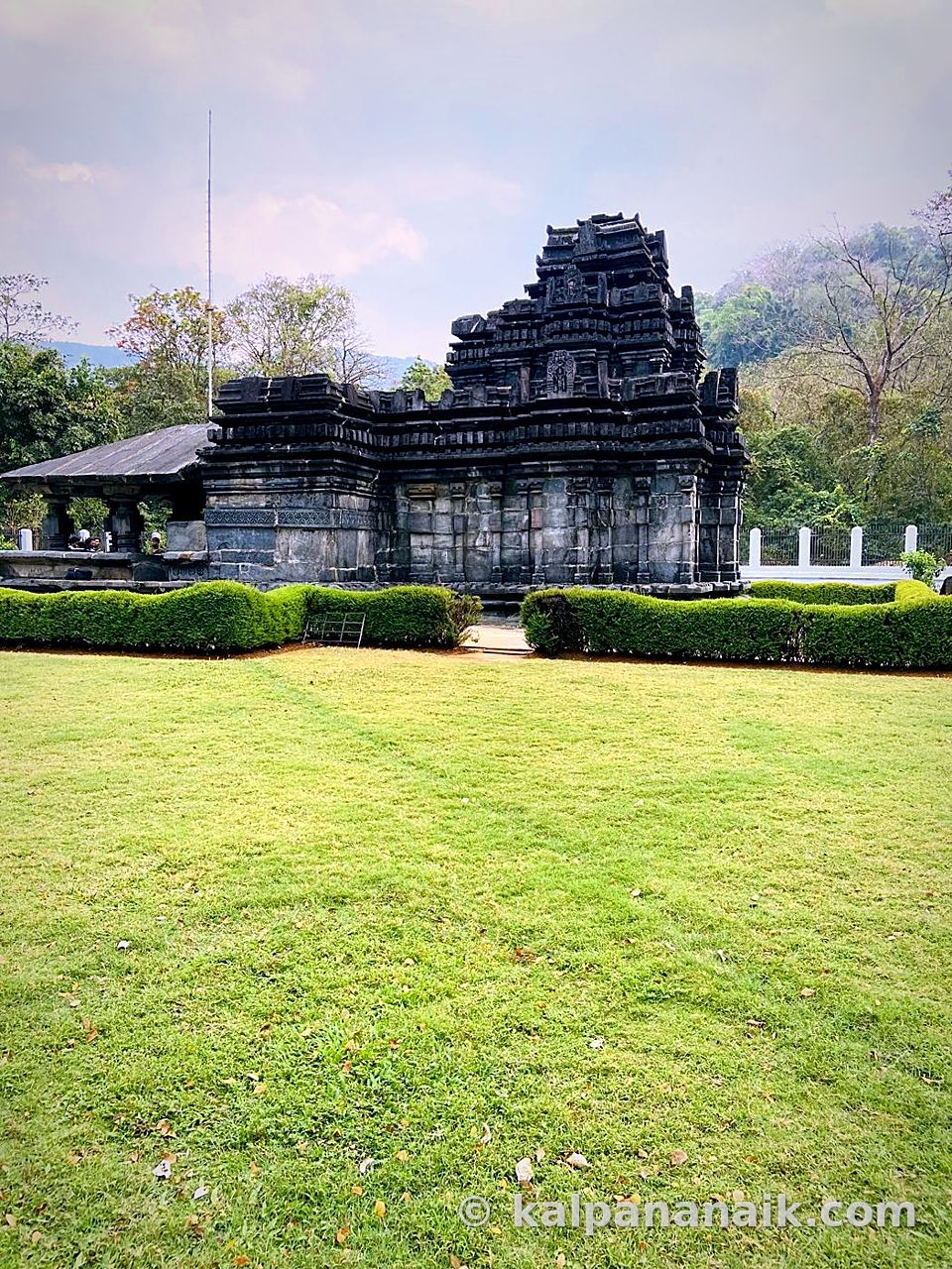 Ancient black-stone temple on a green lawn