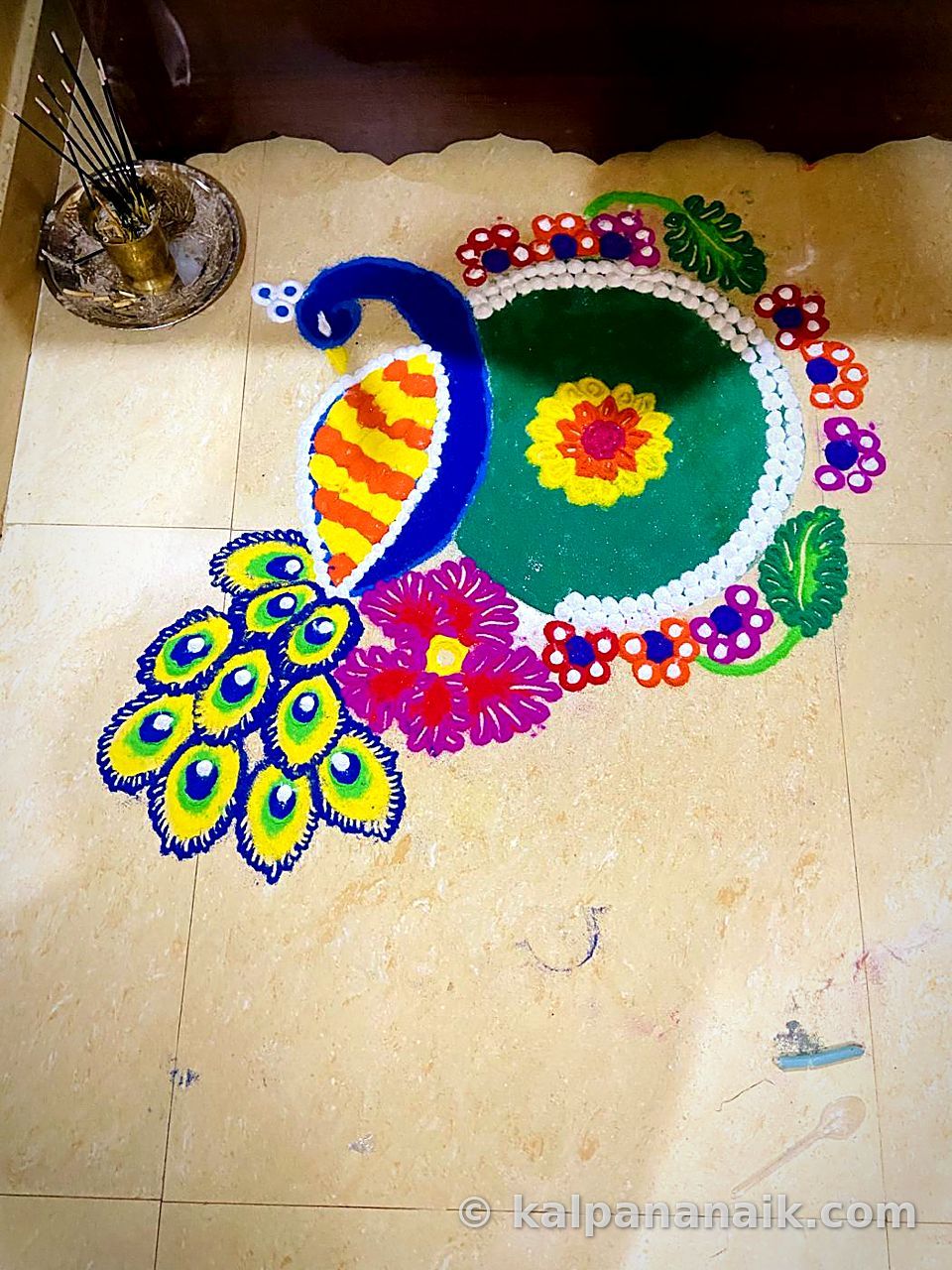 Peacock rangoli in bright powder
