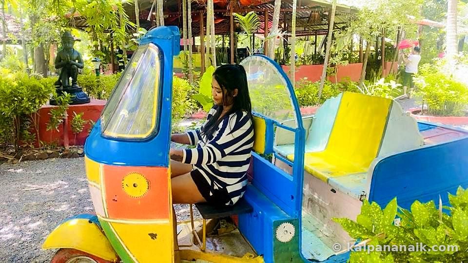 Kalpana sitting in a painted rickshaw