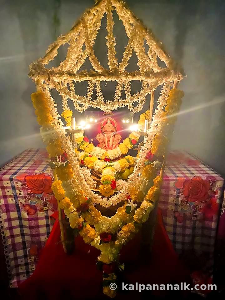 Flower canopy over a lit lamp