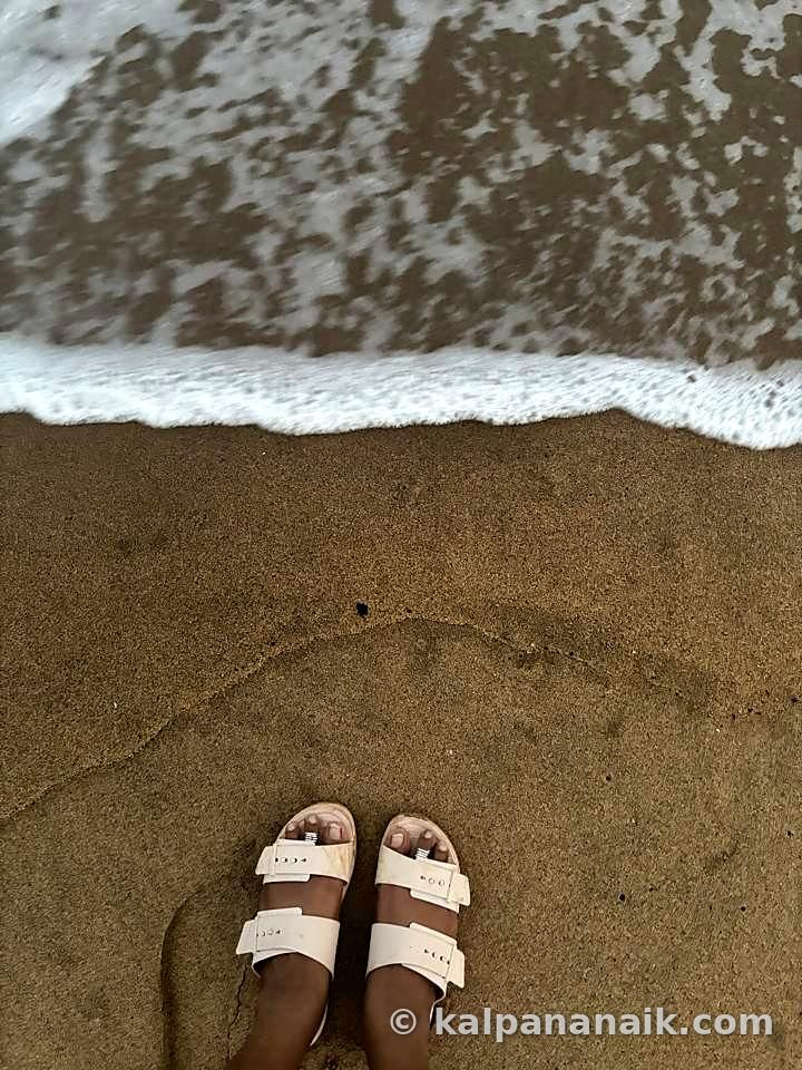 Sandals at the edge of the surf