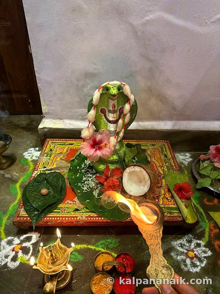 Naga offering with hibiscus and coconut