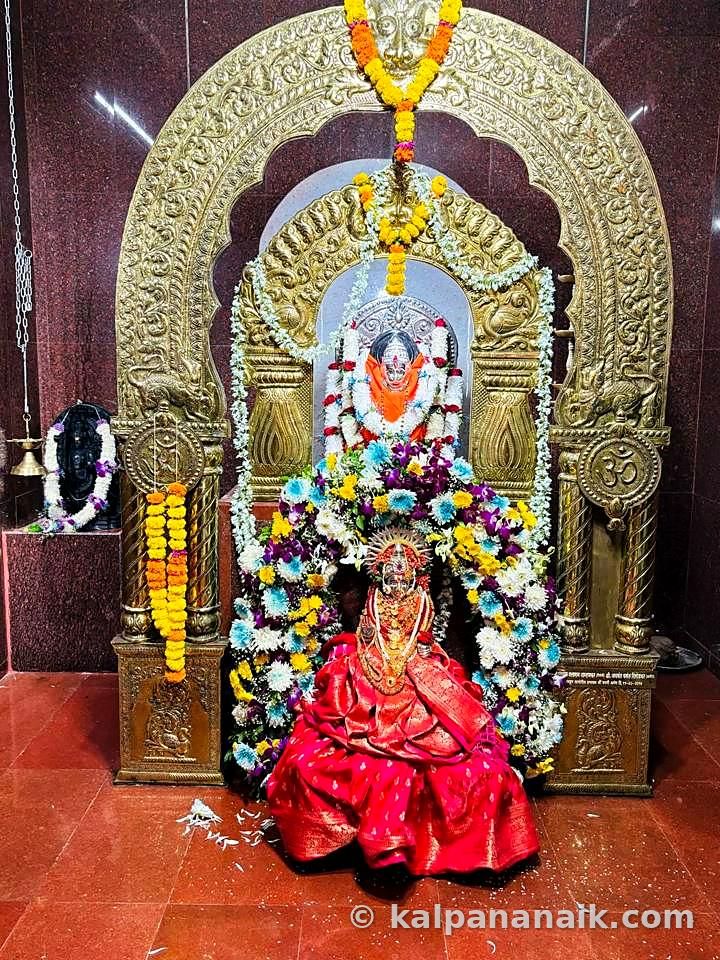 Goddess idol in a carved golden frame
